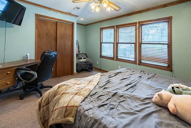 3919 69th St, Urbandale, IA 50322 - bedroom featuring ornamental molding, a closet, carpet flooring, a ceiling fan, and a desk