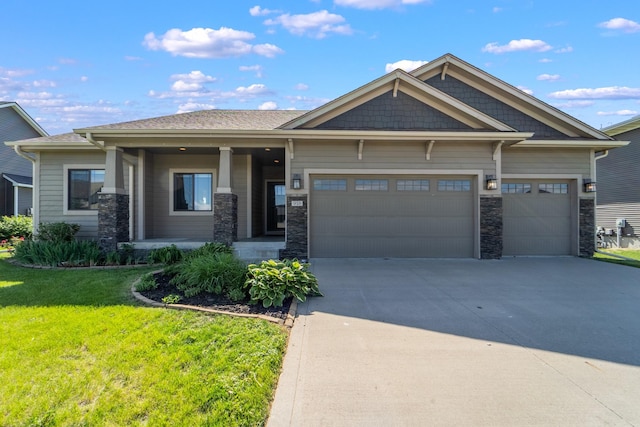 916 NE Silkwood St, Grimes, IA 50111 - view of front of property featuring an attached garage, concrete driveway, a front yard, and stone siding