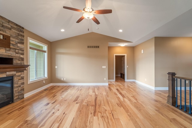 916 NE Silkwood St, Grimes, IA 50111 - unfurnished living room with a fireplace, lofted ceiling, a ceiling fan, light wood-type flooring, and baseboards
