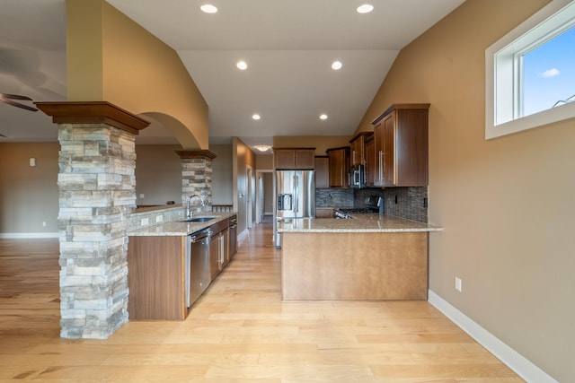 916 NE Silkwood St, Grimes, IA 50111 - kitchen with stainless steel appliances, a peninsula, light stone countertops, lofted ceiling, and a sink
