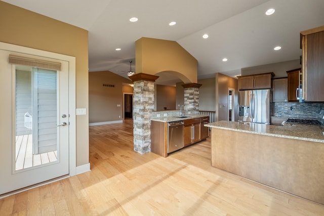 916 NE Silkwood St, Grimes, IA 50111 - kitchen featuring stainless steel appliances, decorative columns, a sink, lofted ceiling, and a peninsula