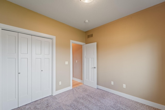 916 NE Silkwood St, Grimes, IA 50111 - unfurnished bedroom featuring baseboards, carpet, and a closet
