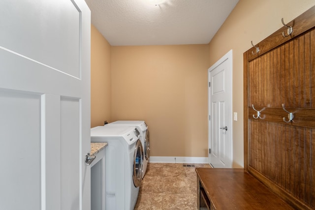 916 NE Silkwood St, Grimes, IA 50111 - laundry area with separate washer and dryer, baseboards, and a textured ceiling