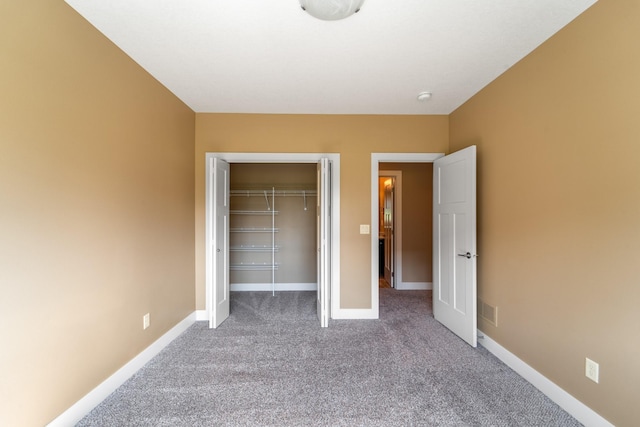 916 NE Silkwood St, Grimes, IA 50111 - unfurnished bedroom featuring carpet, a closet, and baseboards