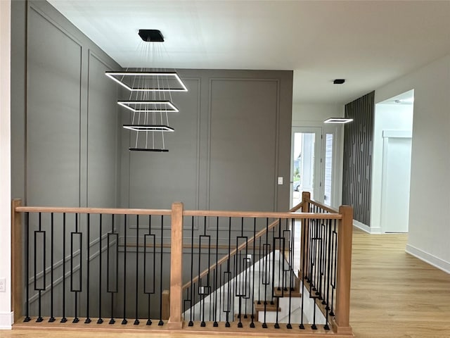 16332 Northpark Dr, Urbandale, IA 50323 - staircase with wood finished floors and baseboards