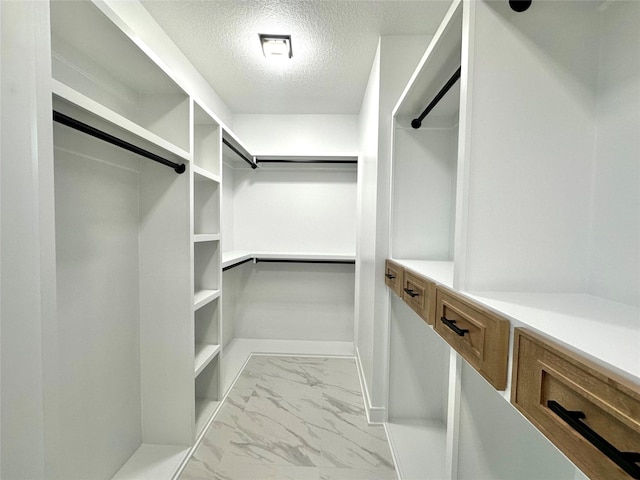16332 Northpark Dr, Urbandale, IA 50323 - spacious closet featuring marble look tiles