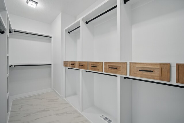 16332 Northpark Dr, Urbandale, IA 50323 - spacious closet featuring light marble finish floors