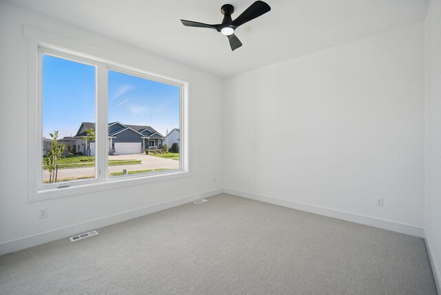 16332 Northpark Dr, Urbandale, IA 50323 - carpeted spare room with baseboards and ceiling fan