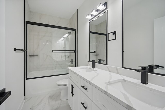 16332 Northpark Dr, Urbandale, IA 50323 - bathroom with marble finish floors, combined bath / shower with glass door, toilet, and double vanity