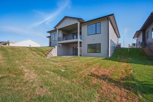 16332 Northpark Dr, Urbandale, IA 50323 - rear view of house with a yard, stairway, a balcony, and cooling unit