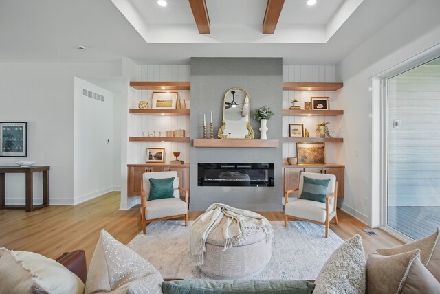 16332 Northpark Dr, Urbandale, IA 50323 - living area featuring light wood finished floors, a glass covered fireplace, baseboards, beamed ceiling, and recessed lighting