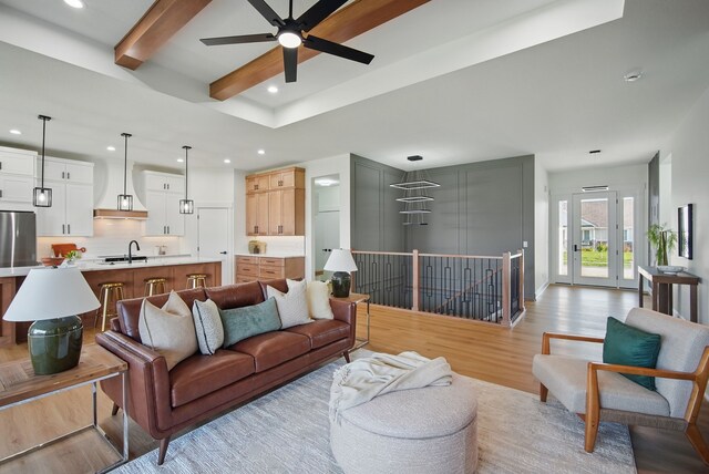 16332 Northpark Dr, Urbandale, IA 50323 - living area featuring light wood finished floors, recessed lighting, a ceiling fan, and beam ceiling