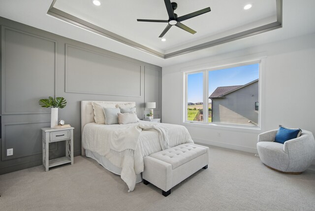 16332 Northpark Dr, Urbandale, IA 50323 - bedroom with a tray ceiling, light carpet, recessed lighting, a ceiling fan, and baseboards