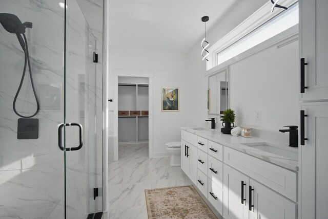 16332 Northpark Dr, Urbandale, IA 50323 - bathroom with a marble finish shower, marble look tiles, double vanity, toilet, and a spacious closet