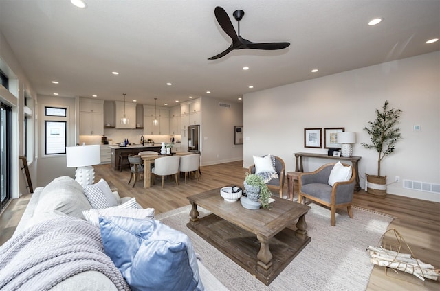 6204 Aspen Dr, West Des Moines, IA 50266 - living room featuring light wood-style floors, a ceiling fan, recessed lighting, and baseboards