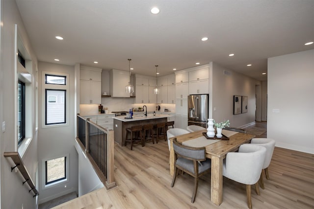 6204 Aspen Dr, West Des Moines, IA 50266 - dining space featuring recessed lighting, light wood-type flooring, and baseboards
