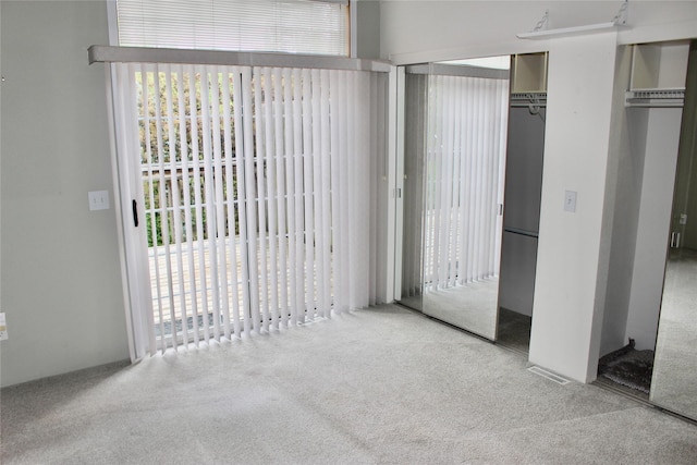 730 Kitterman Cir, Norwalk, IA 50211 - unfurnished bedroom featuring carpet floors and two closets