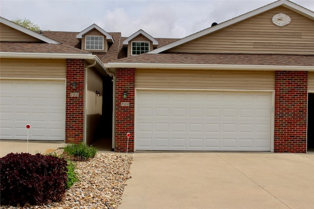 730 Kitterman Cir, Norwalk, IA 50211 - traditional home featuring brick siding, a shingled roof, driveway, and an attached garage