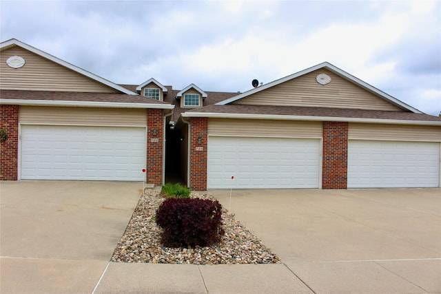 730 Kitterman Cir, Norwalk, IA 50211 - traditional home featuring concrete driveway, brick siding, a garage, and roof with shingles