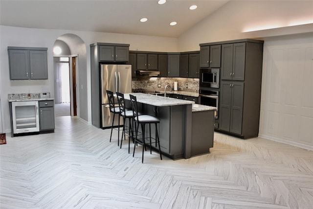 730 Kitterman Cir, Norwalk, IA 50211 - kitchen with beverage cooler, appliances with stainless steel finishes, light stone counters, recessed lighting, and baseboards