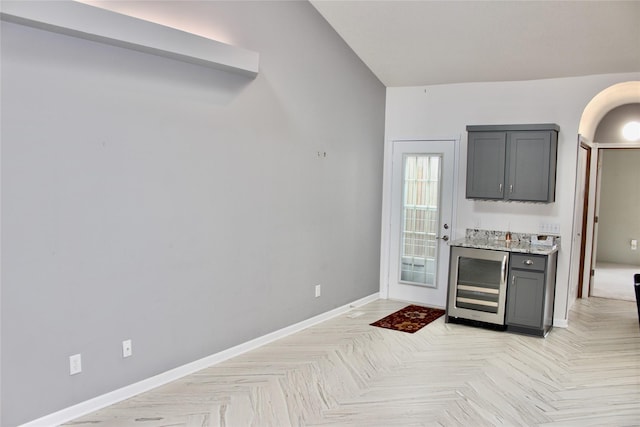 730 Kitterman Cir, Norwalk, IA 50211 - bar with beverage cooler, baseboards, and arched walkways