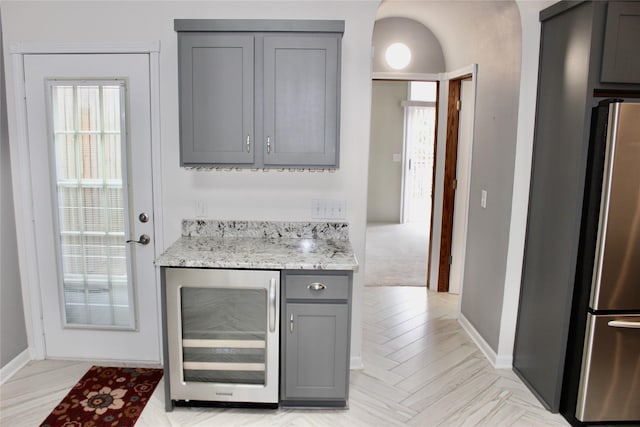 730 Kitterman Cir, Norwalk, IA 50211 - indoor dry bar with wine cooler, freestanding refrigerator, baseboards, and plenty of natural light