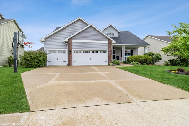 703 NE 46th Ct, Ankeny, IA 50021 - view of front of home with a front lawn, concrete driveway, a garage, and brick siding
