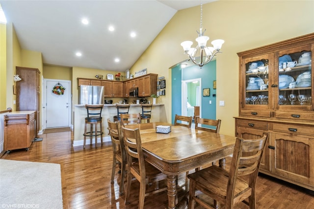 703 NE 46th Ct, Ankeny, IA 50021 - dining space with a chandelier, high vaulted ceiling, wood finished floors, and recessed lighting