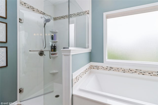 703 NE 46th Ct, Ankeny, IA 50021 - bathroom featuring a bath and a shower stall