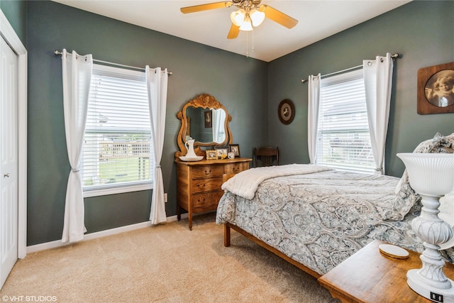 703 NE 46th Ct, Ankeny, IA 50021 - bedroom with light carpet, baseboards, and a ceiling fan