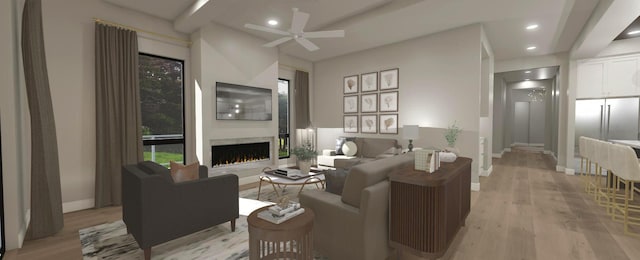 200 S Shore Dr Unit 101, Clear Lake, IA 50428 - living room with a warm lit fireplace, light wood-style floors, a ceiling fan, baseboards, and recessed lighting