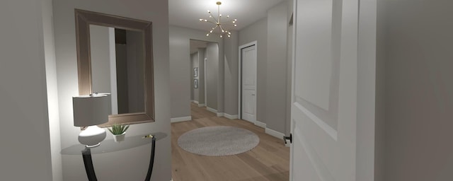 200 S Shore Dr Unit 101, Clear Lake, IA 50428 - hall featuring light wood-style flooring, baseboards, and a chandelier