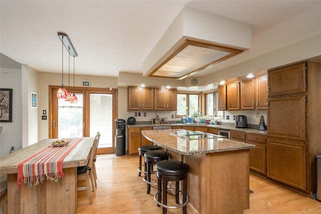 10490 Elmcrest Dr, Clive, IA 50325 - kitchen featuring a center island, brown cabinets, light wood finished floors, a kitchen breakfast bar, and wine cooler