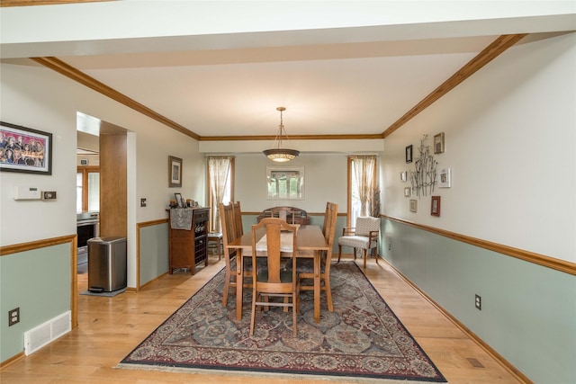 10490 Elmcrest Dr, Clive, IA 50325 - dining area featuring plenty of natural light, ornamental molding, light wood-type flooring, and baseboards