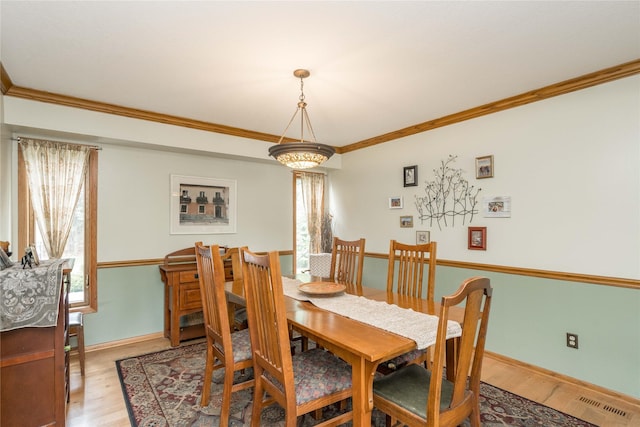 10490 Elmcrest Dr, Clive, IA 50325 - dining space with light wood-style floors, ornamental molding, and baseboards