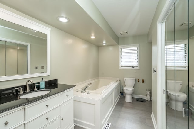 10490 Elmcrest Dr, Clive, IA 50325 - full bathroom with toilet, a bath, vanity, baseboards, and recessed lighting