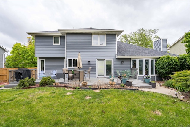 10490 Elmcrest Dr, Clive, IA 50325 - rear view of property with a patio, roof with shingles, and a chimney