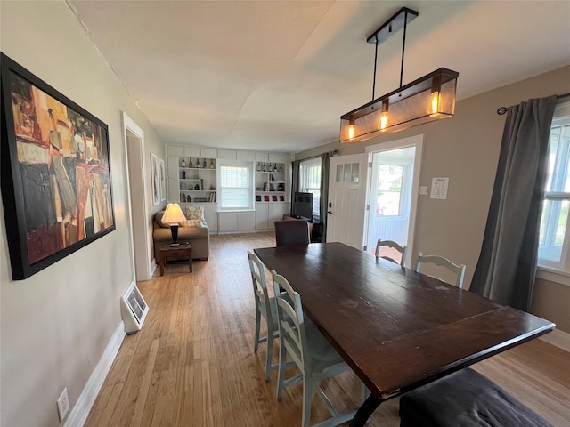 311 W 8th St S, Newton, IA 50208 - dining area featuring light wood-type flooring, baseboards, plenty of natural light, and built in shelves