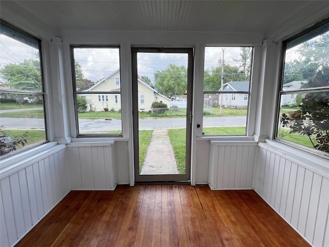 311 W 8th St S, Newton, IA 50208 - unfurnished sunroom with plenty of natural light, wood-type flooring, and wood walls