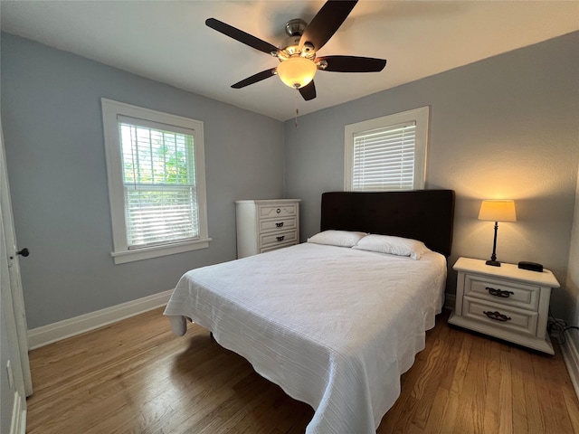 311 W 8th St S, Newton, IA 50208 - bedroom with baseboards, wood finished floors, and ceiling fan
