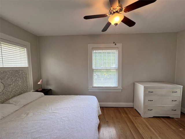 311 W 8th St S, Newton, IA 50208 - bedroom featuring wood finished floors, baseboards, and ceiling fan