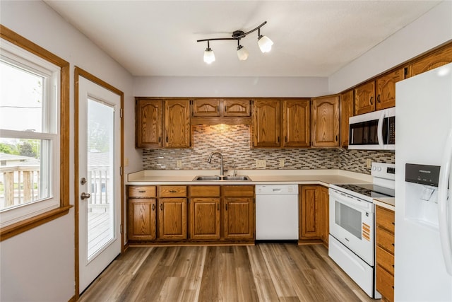 602 SE 7th St, Ankeny, IA 50021 - kitchen with white appliances, a sink, and brown cabinetry
