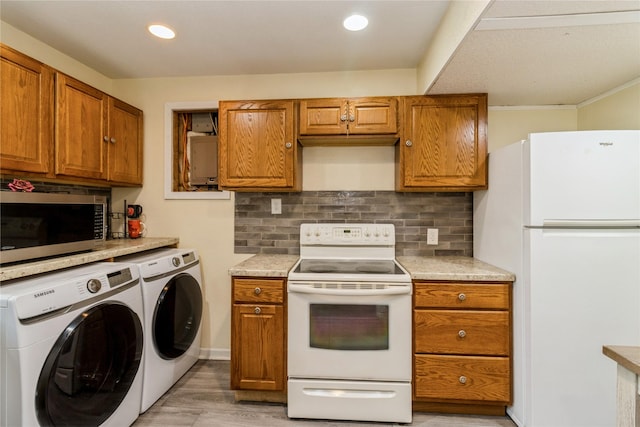 602 SE 7th St, Ankeny, IA 50021 - kitchen featuring white appliances, washing machine and dryer, brown cabinets, recessed lighting, and crown molding