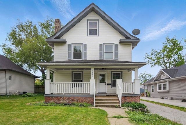 3114 School St, Des Moines, IA 50311 - traditional style home featuring a porch, a front lawn, and a chimney