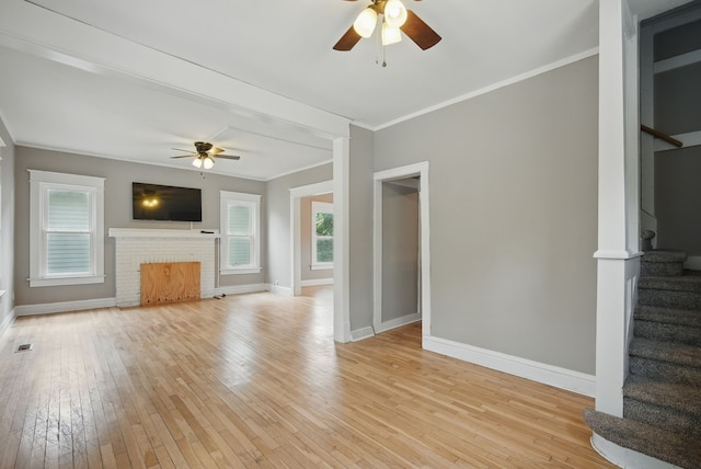 3114 School St, Des Moines, IA 50311 - unfurnished living room with ceiling fan, stairs, baseboards, ornamental molding, and light wood-style floors