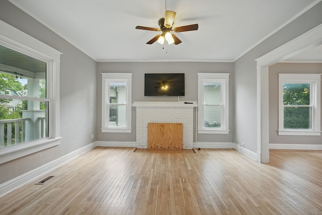 3114 School St, Des Moines, IA 50311 - unfurnished living room featuring hardwood / wood-style flooring, healthy amount of natural light, a ceiling fan, baseboards, and ornamental molding
