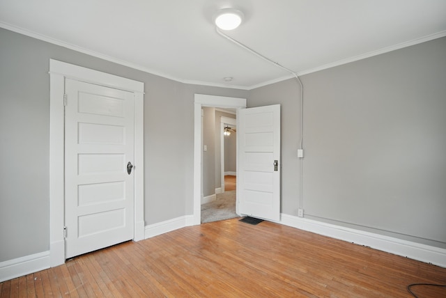3114 School St, Des Moines, IA 50311 - unfurnished bedroom featuring crown molding, baseboards, and light wood-type flooring