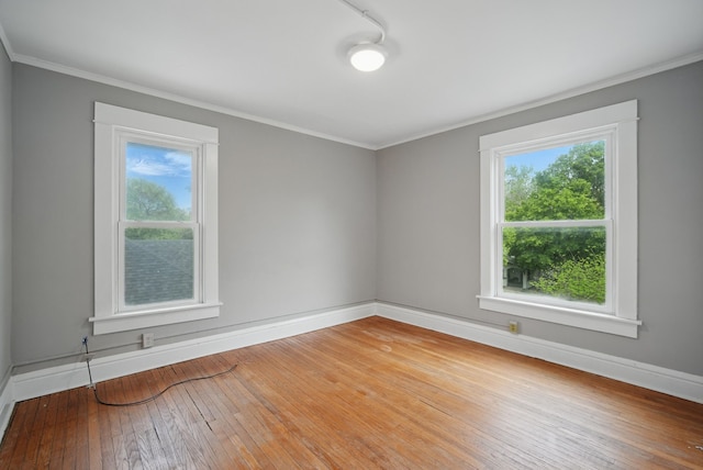 3114 School St, Des Moines, IA 50311 - empty room featuring healthy amount of natural light, baseboards, hardwood / wood-style flooring, and ornamental molding