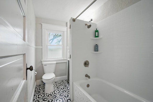 3114 School St, Des Moines, IA 50311 - bathroom with toilet, washtub / shower combination, tile patterned flooring, and baseboards