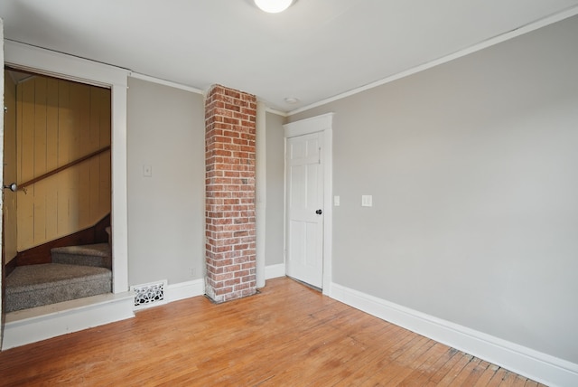 3114 School St, Des Moines, IA 50311 - unfurnished bedroom with light wood-type flooring, baseboards, and ornamental molding